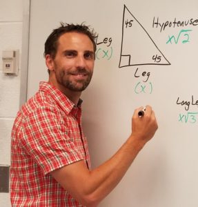 picture of a man standing at a white board.